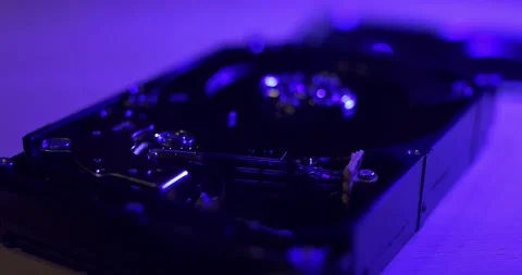 Closeup of HDD Hard Drive under Blue light. Pulling focus over head to platter Stock Footage 132078279