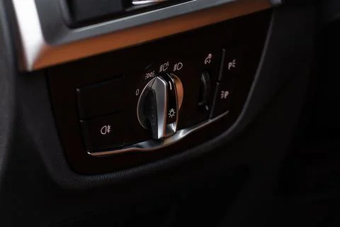 Closeup of the headlight switch control button. Lights control panel in car. Stock Photos