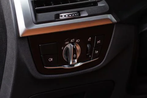 Closeup of the headlight switch control button. Lights control panel in car. Foto stock
