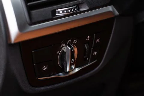 Closeup of the headlight switch control button. Lights control panel in car. Stock Photos