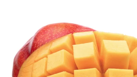 Closeup of hedgehog style cut mango with whole mango on the background. Stock Footage 157049265