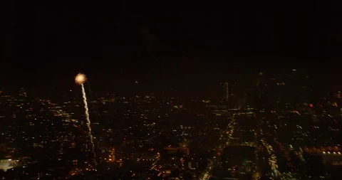 Closeup Helicopter aerial of fireworks exploding over city, night Stock Footage 102211505