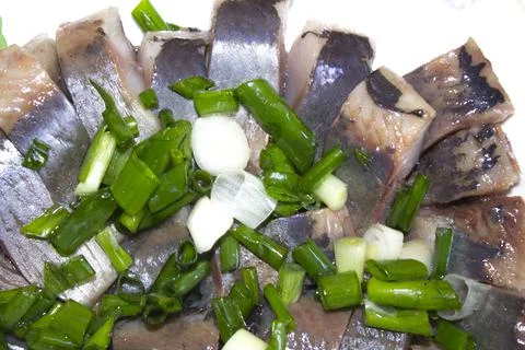 Closeup herring fish slice on plate Stock Photos