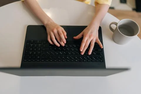 Closeup high-angle view of unrecognizable pupil school boy typing on laptop Stock Photos