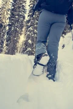 Closeup of hiking boots on a snow path. Stock Photos