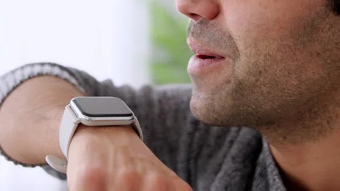 Closeup of hispanic man talking on watch Stock Footage 262383459