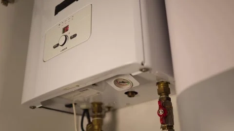 Closeup of home heating boiler with digital display and control knob showing sys Stock Footage 318867845
