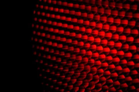 Closeup honeycomb grid texture with red light. Red and dark metal hexagon sha Fotos de archivo