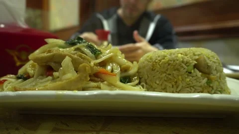 Closeup of a hot and steaming chifa plate of combined rice, noodles, chicken and Stock Footage 161444653