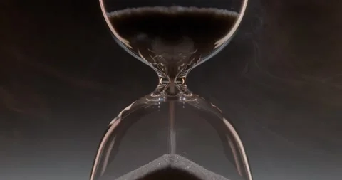 Closeup of hourglass over a dark dramatic background. Video stock 327145919