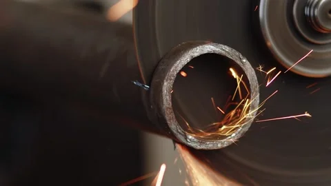 Closeup of how round piece is cut off from metal hollow pipe using cutting disc Stock Footage 170184522