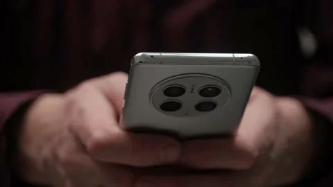 Closeup of Huawei mate 50 pro phone in male hands. April 4, 2023 Angarsk, Russia Stock Footage 239641429