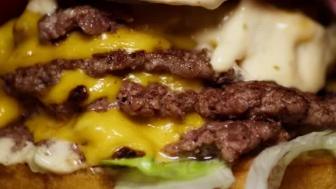 Closeup of a Huge Fat Cheeseburger rotating on a display, Cholesterol Fast Food. Stock Footage 227227866
