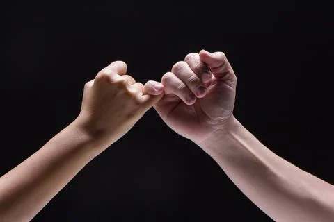 Closeup human hand ,Hook each other's little finger,to be sign and symbol to Stock-Fotos