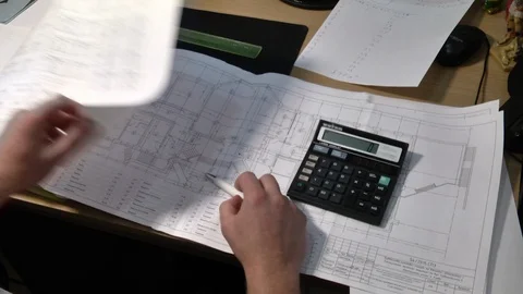 Closeup of human hands drawing architectural plan with pen and calculator. Stock Footage 122095882