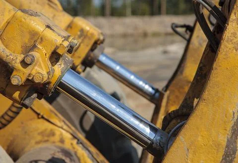 Closeup of hydraulic actuators on front loader bucket, Finland Stock Photos