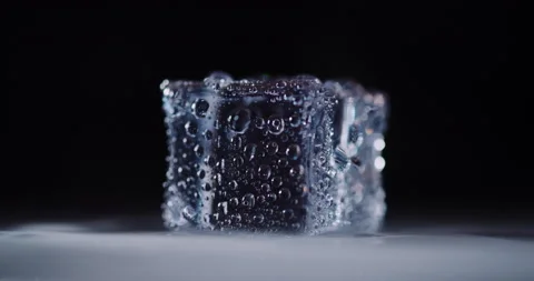 Closeup ice cubes rotating on dark background. Stock Footage 160667095