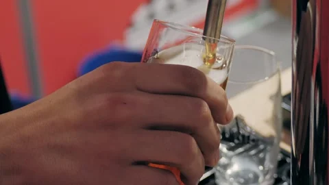 Closeup image of a bartender pouring a fresh craft beer into a glass at a bar or Stock Footage 279758146