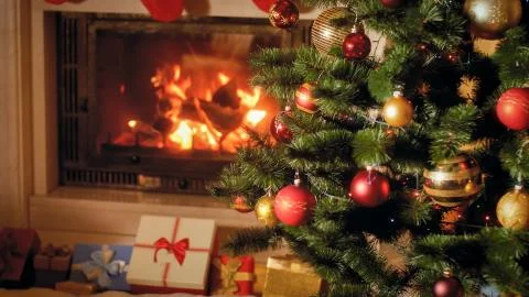 Closeup image of big stack of Christmas gifts and presents next to burning Stock Photos