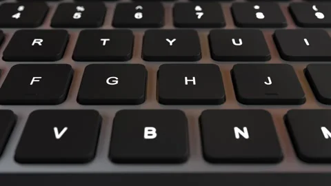Closeup image of a black keyboard with white keys, a computer input device Stock Footage 267882186