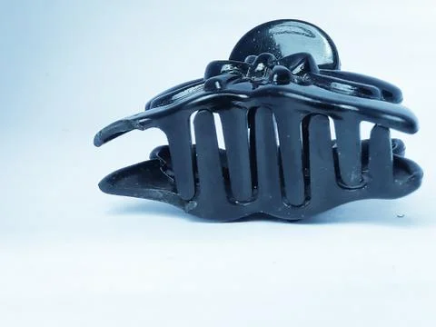 A closeup image of a claw type party hair clip placed isolated in a white bac Stock Photos