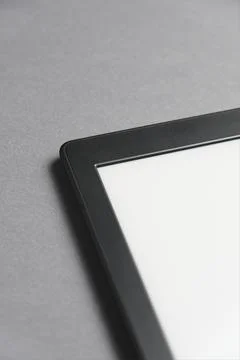 Closeup image of an electronic reader with blank screen on a grey surface. Foto stock
