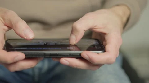 This closeup image features hands actively engaged with a smartphone Video stock 317022434