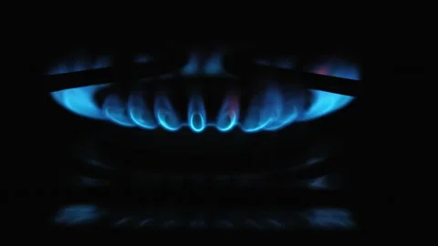 A CloseUp Image Featuring a Blue Flame Emanating from a Gas Burner in a Kitchen Stock Footage 313746077