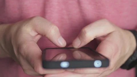 A closeup image featuring a person utilizing a smartphone, emphasizing Video stock 289218896