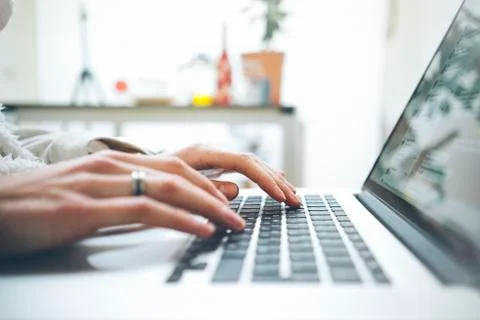 Closeup image of female hands using modern laptop in interior Stock Photos