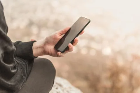 Closeup image of female hands using smartphone in mountain day, search or soc Stock Photos