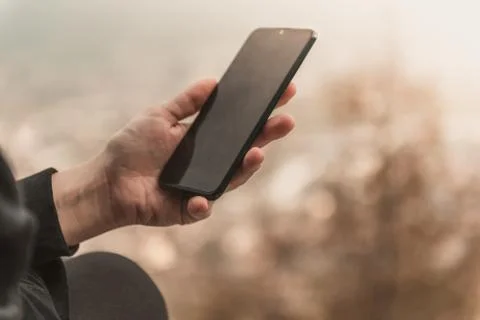 Closeup image of female hands using smartphone in mountain day, search or soc Fotos Stock