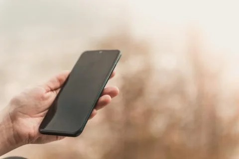 Closeup image of female hands using smartphone in mountain day, search or soc Stock Photos