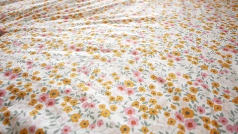 A CloseUp Image of a Hand Resting on a Beautiful Floral Patterned Fabric Surface Stock Footage 280530932