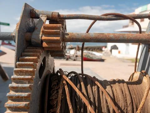 Closeup image of old rusty gears and metal cable of sea port equipment Stock Photos