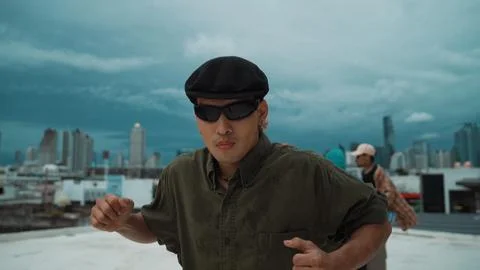 Closeup image of profession hipster dancing break dance at rooftop. Endeavor. 库存照片