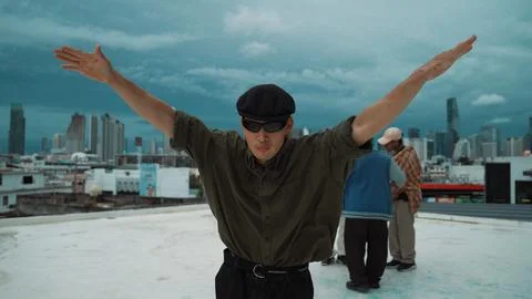 Closeup image of profession hipster dancing break dance at rooftop. Endeavor. Stock Photos