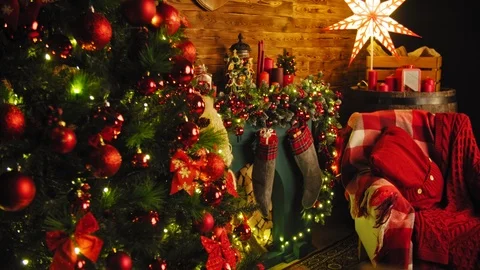 Closeup image of red gift box on wooden table in front of burning fireplace and Stock Footage 99134985