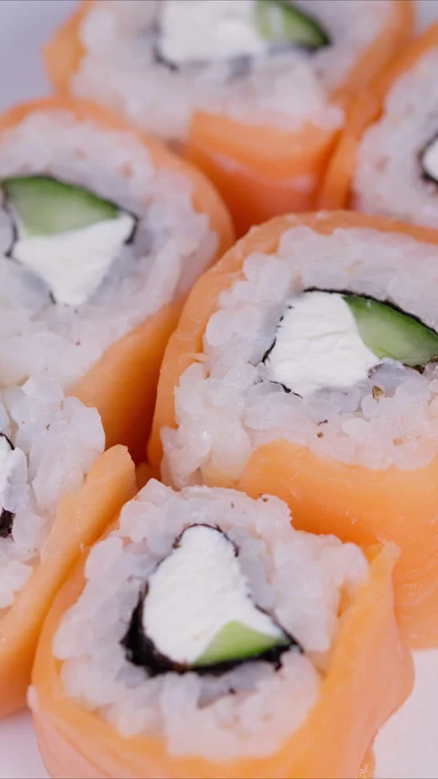 Closeup image of salmon sushi rolls with fresh ingredients. Detailed studio imag Stock Footage 333865652