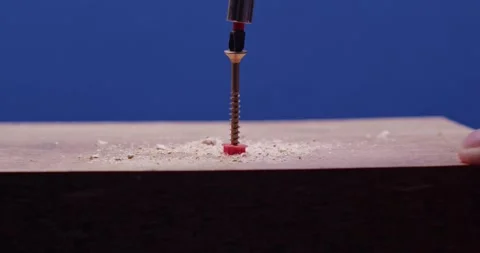 A closeup image of a screw in wood, showcasing craftsmanship and detail in Stock Footage 297953133