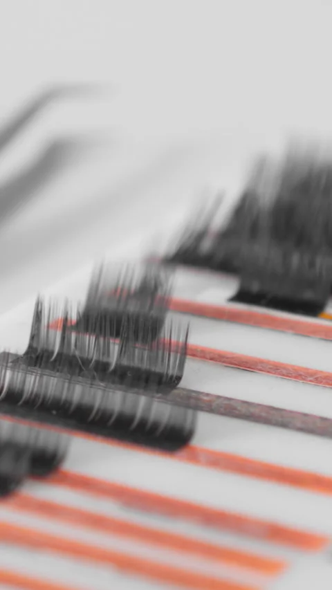 CloseUp image showing professional lash extensions, tweezers, and other beauty Stock Footage 293146292