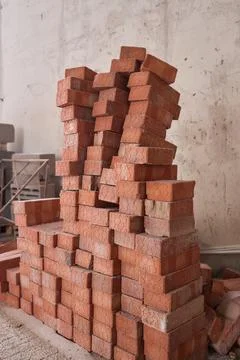 A closeup image of Stacked Red Bricks showcased in a dynamic Construction Stockfoto's