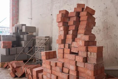 A closeup image of Stacked Red Bricks showcased in a dynamic Construction 写真素材