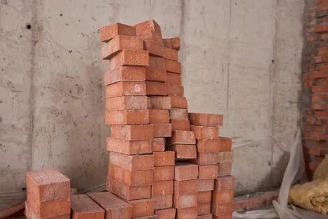 A closeup image of Stacked Red Bricks showcased in a dynamic Construction Stock Photos