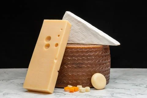 A closeup image of a white Akawi, Cheddar and Queso Blanco cheese and a small Stock Photos