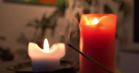 Closeup of incense burning with candles on the background. Relax concept Stock Footage 146177648