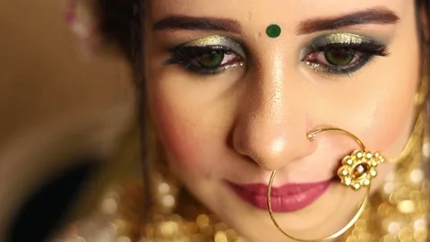 Closeup of Indian  bride smiling and opening Eyes toward the camera Stock Footage 135377988