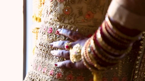 Closeup of an Indian brides hand adorned with traditional ceremonial jewlery and Stock Footage 123550317
