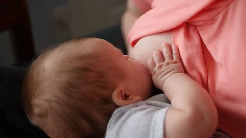 Closeup of Infant on Breast while Feeding Stock Footage 89452720