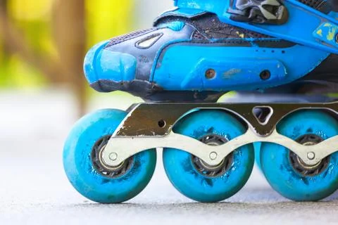 Closeup of inline roller skates with blue wheels. Stock Photos